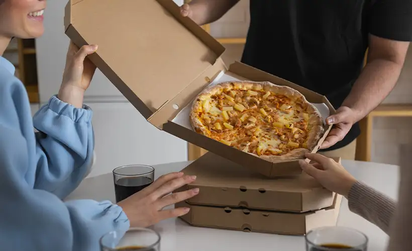 group-friends-eating-pizza-home-together-1-scaled.png